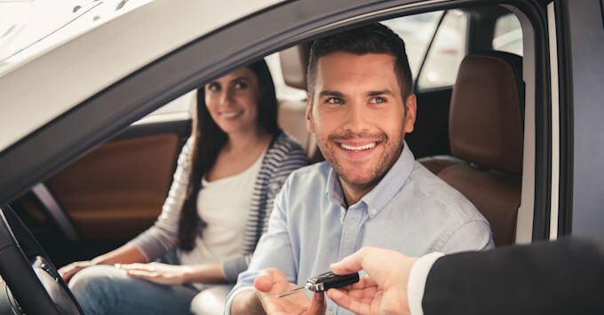 Young couple in their new car